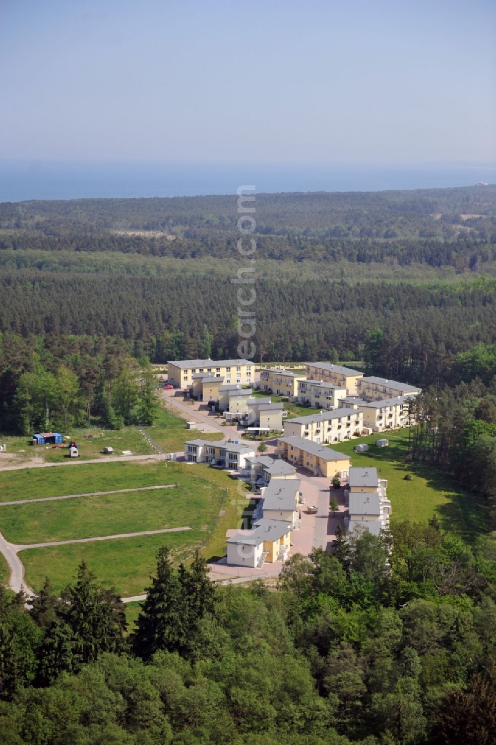 Seeheilbad Graal-Müritz from the bird's eye view: Blick auf den Ferienwohnpark im Küstenwald der HAWO Bauträger KG in unmittelbarer Strandnähe im Ostseeheilbad Graal-Müritz. Aus einer ehemaligen NVA Liegenschaft entstanden bisher in zwei Bauabschnitten attraktive Ferienhäuser und Ferienwohneinheiten zum Verkauf und zur Vermietung. View of the coastal forest of the housing estate developers HAWO KG near the beach in the spa town of Graal Müritz.