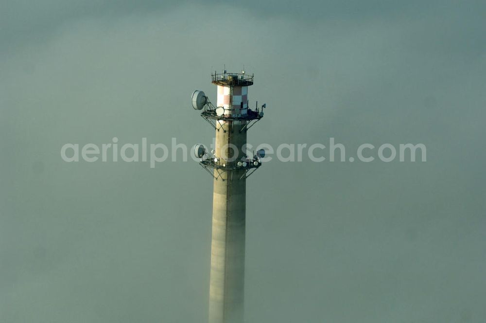 Aerial photograph Dessau-Roßlau - Ein Fernemeldeturm / Funkturm an der Schlagbreite in Dessau-Roßlau ragt aus Wolken hervor.