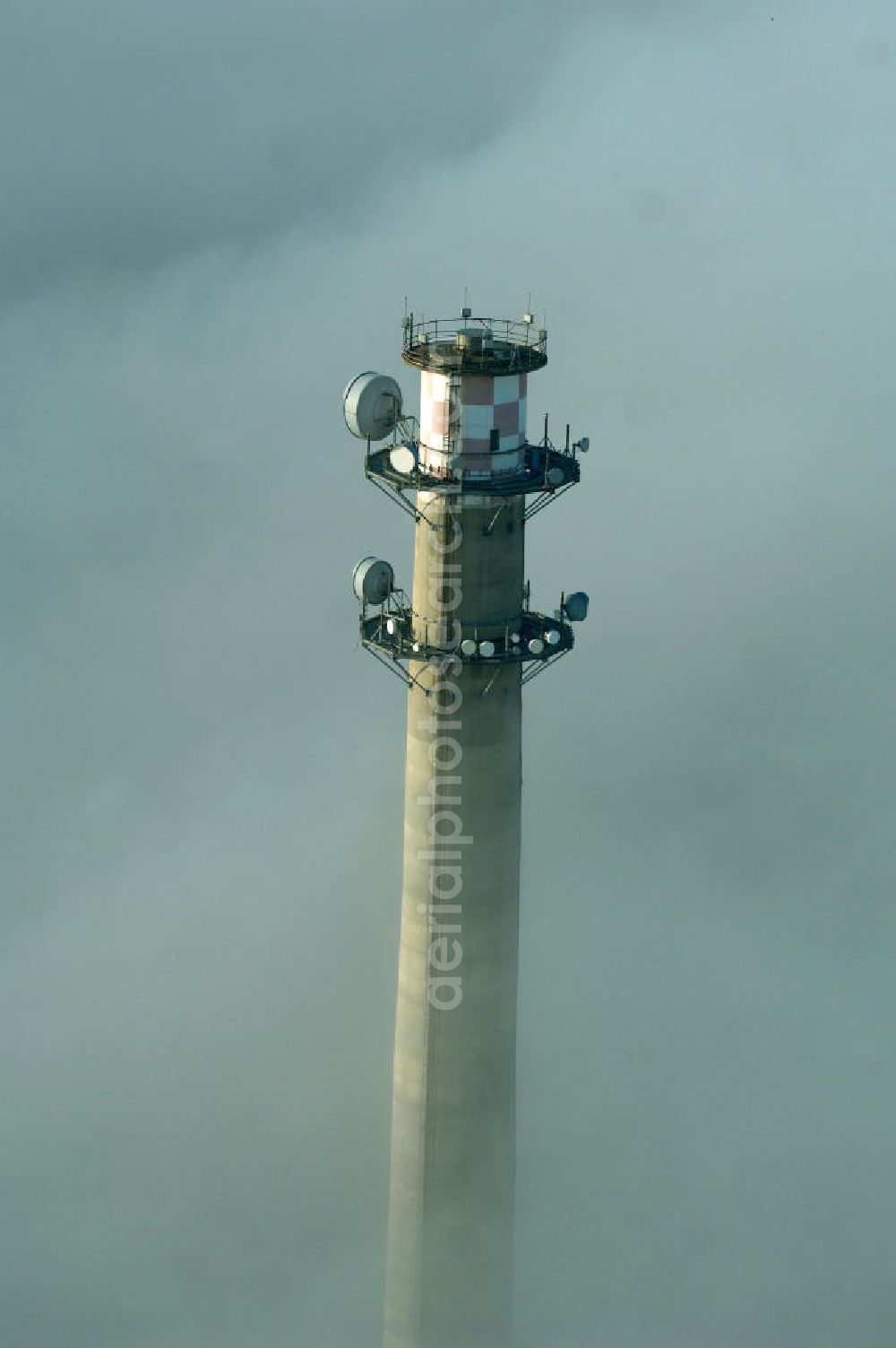 Dessau-Roßlau from above - Ein Fernemeldeturm / Funkturm an der Schlagbreite in Dessau-Roßlau ragt aus Wolken hervor.