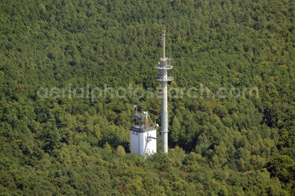 Rauen from above - Transmission tower radio mast of German Funkturm in the Mountains of Rauen in Rauen in the state of Brandenburg. An outbuilding with antenna stands adjacent to the actual tower. The compound is located amidst a forest