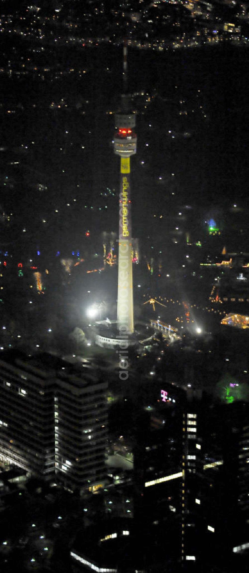 Aerial photograph Dortmund - Nachtluftbild vom Fernsehturm Florianturm in Dortmund - Nordrhein-Westfalen / NW. Das 1959 erbaute Wahrzeichen der Stadt dient auch als Werbefläche, hier für die Fluggesellschaft Germanwings. Aerial night photograph / night shot of the Florianturm called television tower in Dortmund - Nort Rhine-Westphalia / NW. The town's landmark was built in 1959 and is also used as advertising space / ad space, in this case for the German airline Germanwings. -