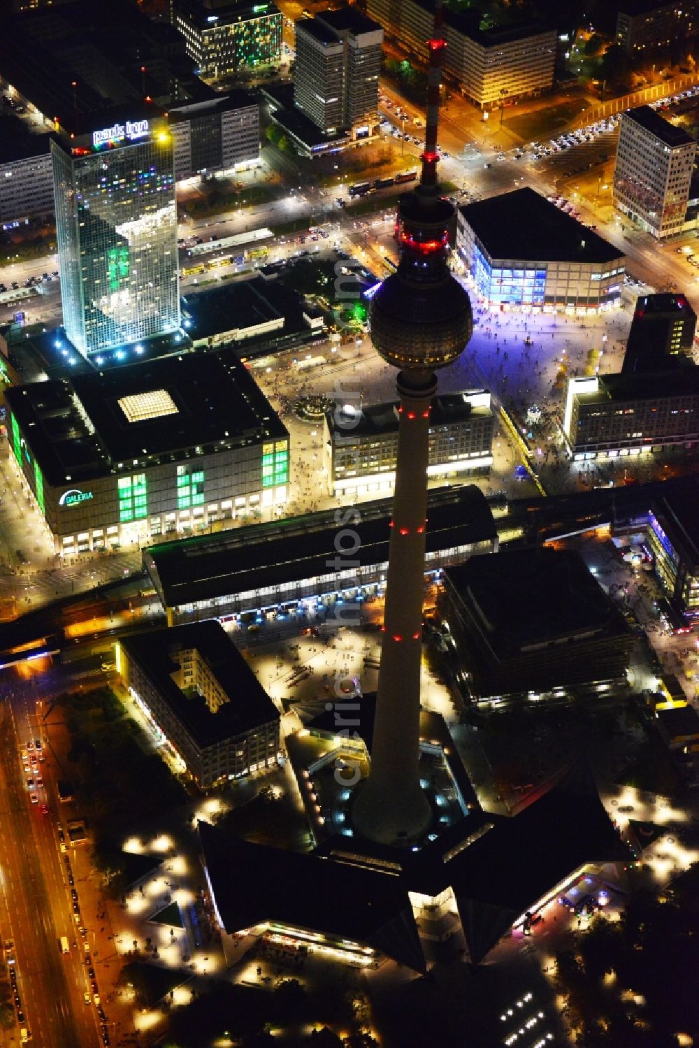 Berlin from above - Night aerial view with an impressive view of the attractions of the annual Festival of Lights at Alexanderplatz in Berlin television tower in the city center of the capital, Berlin