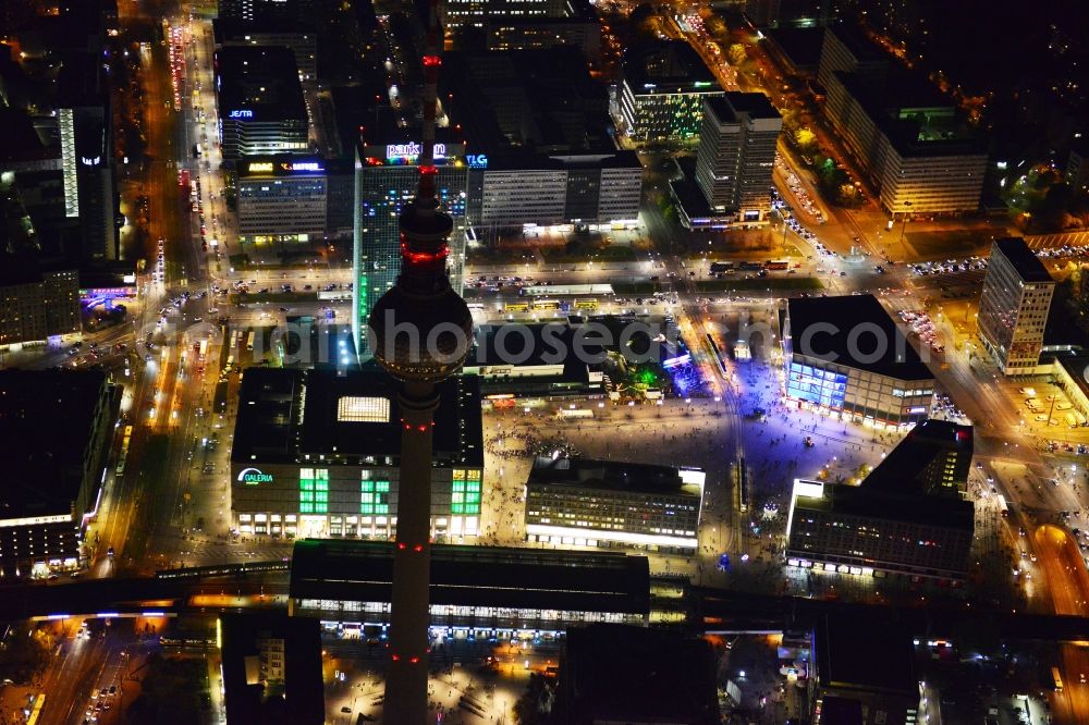 Berlin from the bird's eye view: Night aerial view with an impressive view of the attractions of the annual Festival of Lights at Alexanderplatz in Berlin television tower in the city center of the capital, Berlin