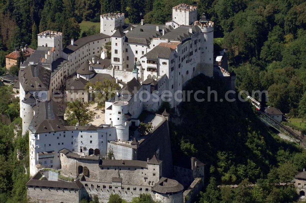 Salzburg from the bird's eye view: Die 900 Jahre alte Festung Hohensalzburg, das Wahrzeichen der Stadt, ist Europas größte und noch am besten erhaltene Burganlage. Die FestungsBahn fährt Besucher in das Innere der Burg. Sie ist rechts im Bild zu erkennen. Salzburg 2007/07/14 Festung Hohensalzburg is a castle in the Austrian city of Salzburg. It sits on Festungberg hill and one of the largest medieval castles in Europe. On the ride side of the picture is the railroad, that carries visitors to the castle.