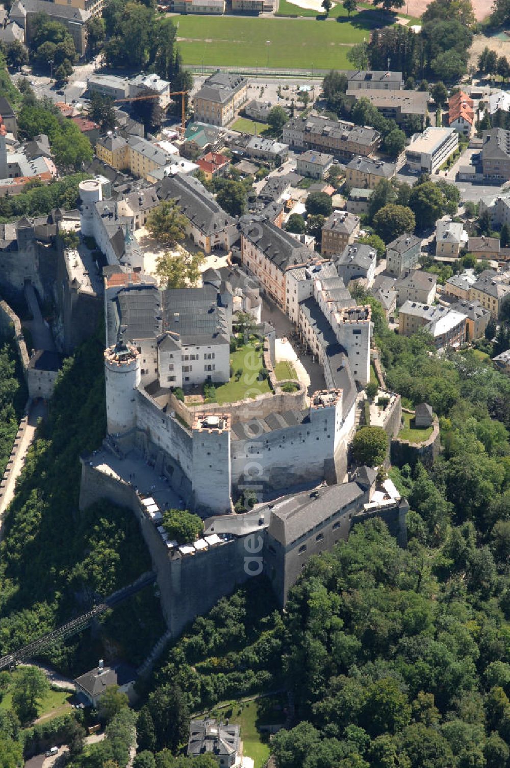 Aerial image SALZBURG - Die 900 Jahre alte Festung Hohensalzburg, das Wahrzeichen der Stadt, ist Europas größte und noch am besten erhaltene Burganlage. Heute gilt sie als Europas größte Festungsanlage mit mehr als 14.000 m² Baufläche. Salzburg 2007/07/14 Festung Hohensalzburg is a castle in the Austrian city of Salzburg. It sits on Festungberg hill. With a length of 250 meters and a width of 150 meters, it is one of the largest medieval castles in Europe.