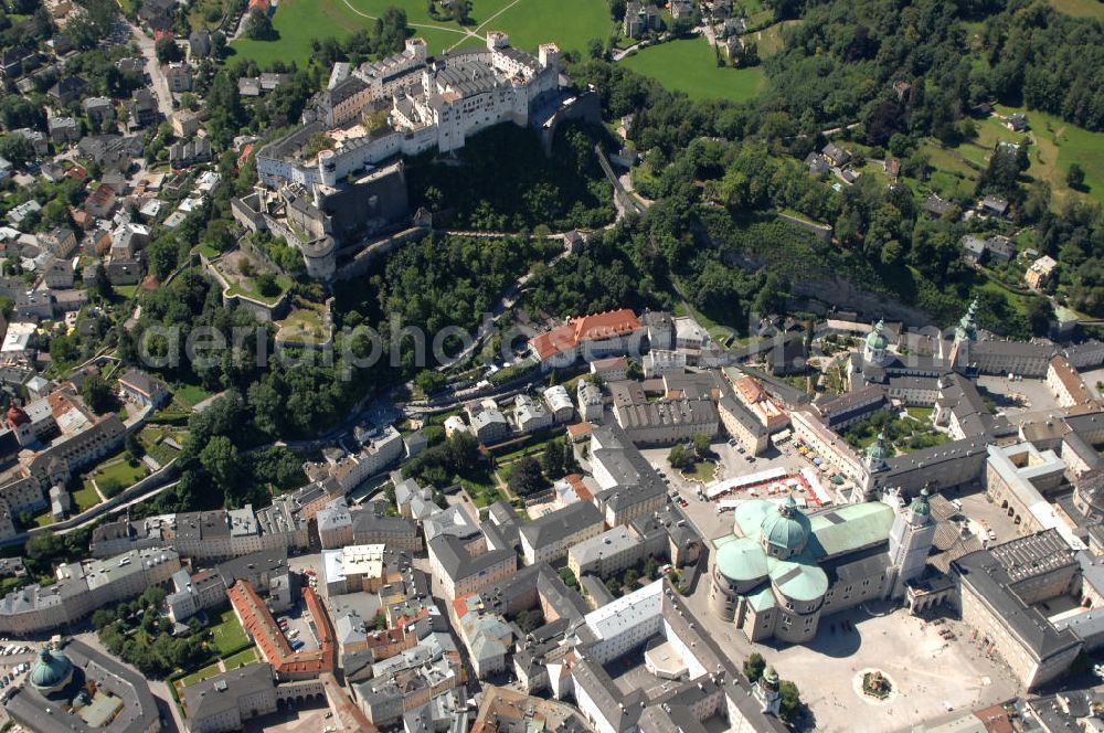 SALZBURG from above - Die 900 Jahre alte Festung Hohensalzburg, das Wahrzeichen der Stadt, ist Europas größte und noch am besten erhaltene Burganlage. Heute gilt sie als Europas größte Festungsanlage mit mehr als 14.000 m² Baufläche. Salzburg 2007/07/14 Festung Hohensalzburg is a castle in the Austrian city of Salzburg. It sits on Festungberg hill. With a length of 250 meters and a width of 150 meters, it is one of the largest medieval castles in Europe.