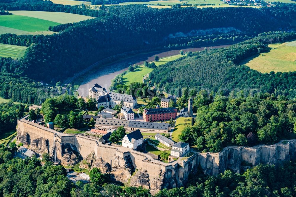 Königstein from the bird's eye view: The Fortress Koenigstein at the river Elbe in the county district of Saxon Switzerland East Erzgebirge in the state of Saxony. The fortress is one of the largest mountain fortresses in Europe and is located amidst the Elbe sand stone mountains on the flat top mountain of the same name