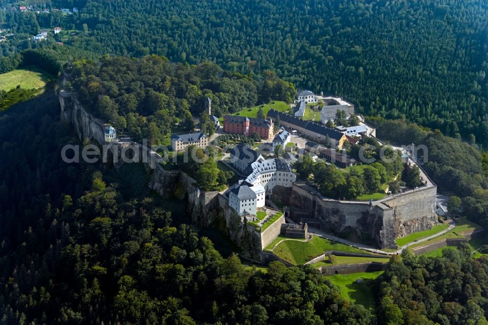 Königstein from the bird's eye view: The Fortress Koenigstein at the river Elbe in the county district of Saxon Switzerland East Erzgebirge in the state of Saxony. The fortress is one of the largest mountain fortresses in Europe and is located amidst the Elbe sand stone mountains on the flat top mountain of the same name