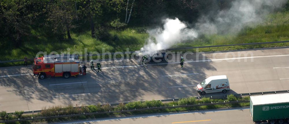 Aerial photograph Dessau - Blick auf einen Feuerwehreinsatz zur Löschung eines PKW- Brandes auf der Autobahn A9 / E51 bei Dessau. View of a fire department for cancellation of a car fire on the highway A9 / E51 in Dessau.