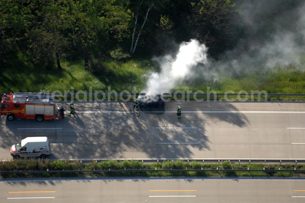 Dessau from above - Blick auf einen Feuerwehreinsatz zur Löschung eines PKW- Brandes auf der Autobahn A9 / E51 bei Dessau. View of a fire department for cancellation of a car fire on the highway A9 / E51 in Dessau.