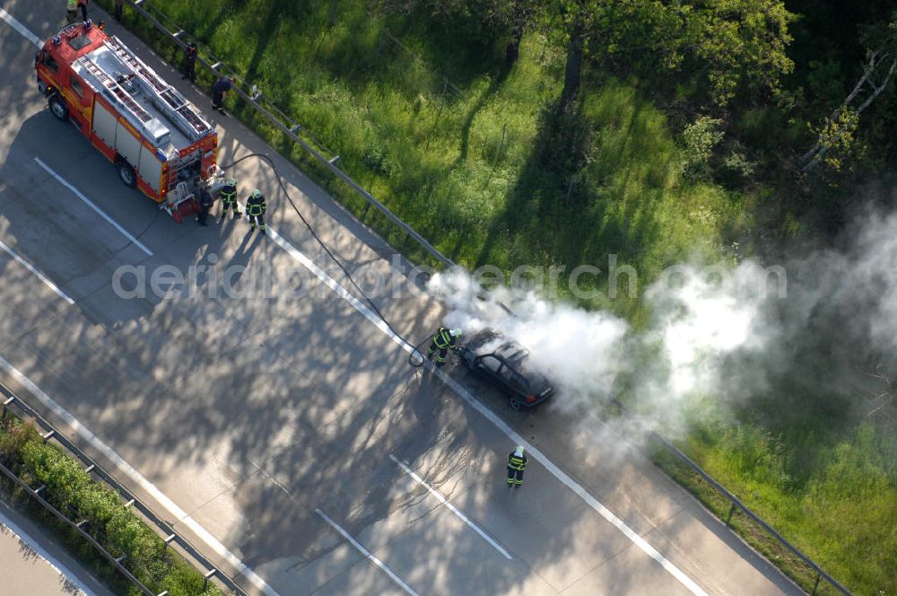 Dessau from the bird's eye view: Blick auf einen Feuerwehreinsatz zur Löschung eines PKW- Brandes auf der Autobahn A9 / E51 bei Dessau. View of a fire department for cancellation of a car fire on the highway A9 / E51 in Dessau.