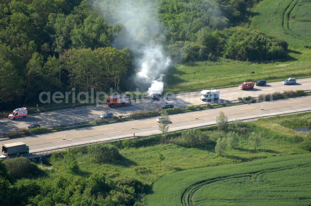 Dessau from the bird's eye view: Blick auf einen Feuerwehreinsatz zur Löschung eines PKW- Brandes auf der Autobahn A9 / E51 bei Dessau. View of a fire department for cancellation of a car fire on the highway A9 / E51 in Dessau.