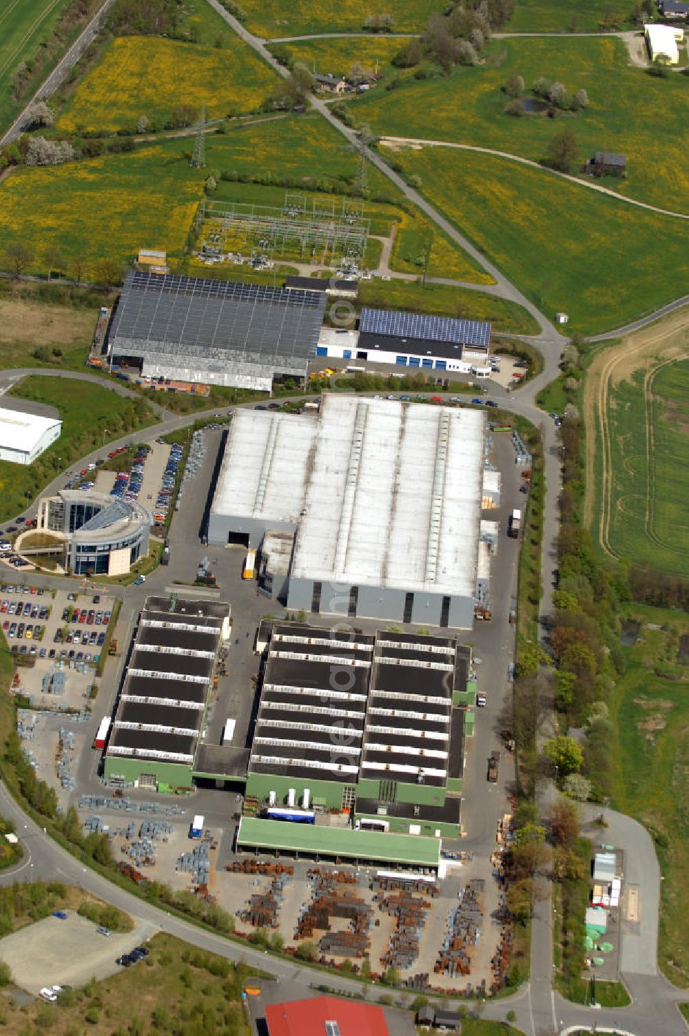 Oelsnitz from the bird's eye view: Blick auf die Firma Meiser Gitterroste im Industriegebiet am Johannisberg. Edmund Meiser gründete 1956 die Stahl- und Eisenhandelgesellschaft. Kontakt: Meiser Gitterroste KG, Am Lehmteich 3, 08606 Oelsnitz, Tel. +49(0)37421 50 0, Fax +49(0)37421 50 2120,