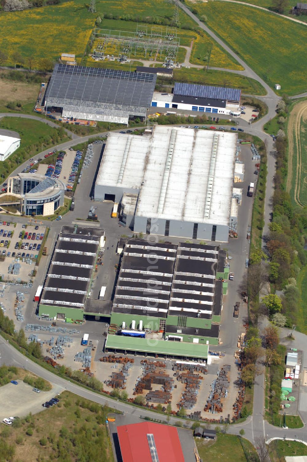 Aerial image Oelsnitz - Blick auf die Firma Meiser Gitterroste im Industriegebiet am Johannisberg. Edmund Meiser gründete 1956 die Stahl- und Eisenhandelgesellschaft. Kontakt: Meiser Gitterroste KG, Am Lehmteich 3, 08606 Oelsnitz, Tel. +49(0)37421 50 0, Fax +49(0)37421 50 2120,