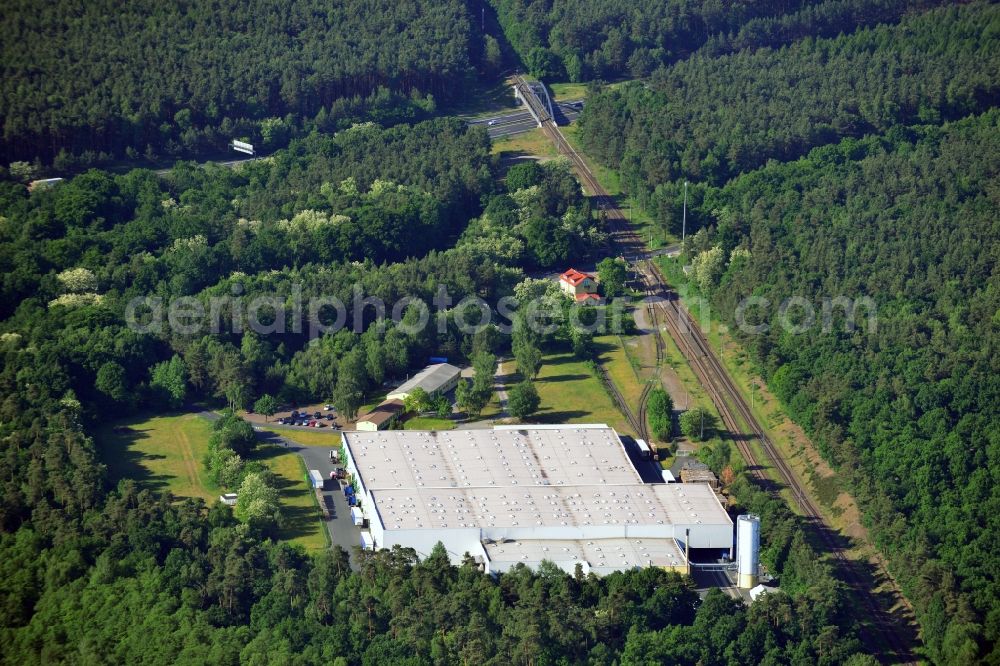 Schwielowsee from above - Company compound and building of Schultze Logistics GmbH in the borough of Schwielowsee in the state of Brandenburg. Schielowsee is a borough in the county district of Potsdam-Mittelmark. The company with its large hall sits in a forest on the Lienewitz train station, next to railway tracks