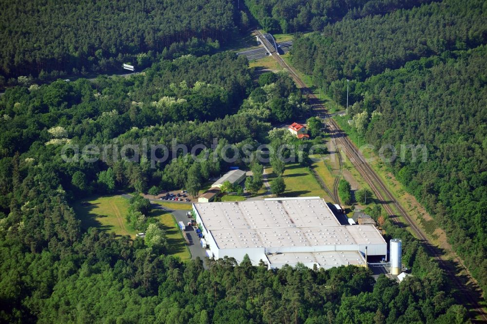 Aerial image Schwielowsee - Company compound and building of Schultze Logistics GmbH in the borough of Schwielowsee in the state of Brandenburg. Schielowsee is a borough in the county district of Potsdam-Mittelmark. The company with its large hall sits in a forest on the Lienewitz train station, next to railway tracks