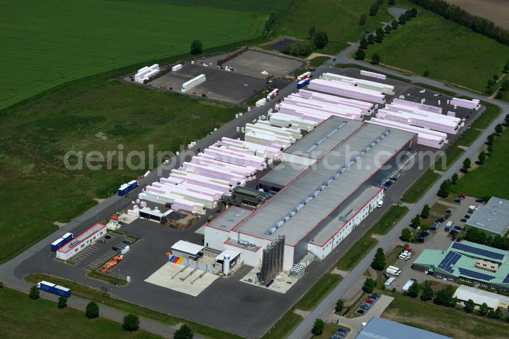 Aerial photograph Wittenberge - Company building and production site of Austrotherm company in the Northwest of Wittenberg in the state of Brandenburg. Austrotherm produces insulating material on site in the industrial area of Wittenberg. View of the company building and material on the compound