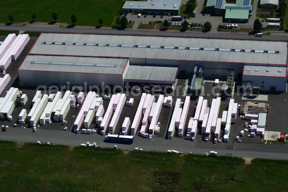 Wittenberge from above - Company building and production site of Austrotherm company in the Northwest of Wittenberg in the state of Brandenburg. Austrotherm produces insulating material on site in the industrial area of Wittenberg. View of the company building and material on the compound