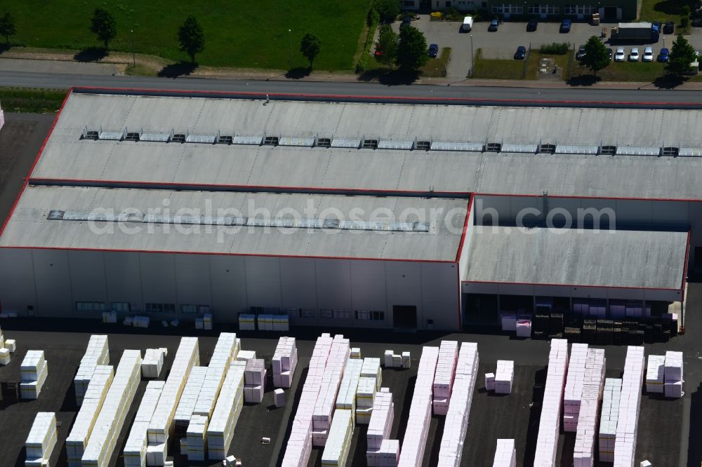 Wittenberge from the bird's eye view: Company building and production site of Austrotherm company in the Northwest of Wittenberg in the state of Brandenburg. Austrotherm produces insulating material on site in the industrial area of Wittenberg. View of the company building and material on the compound