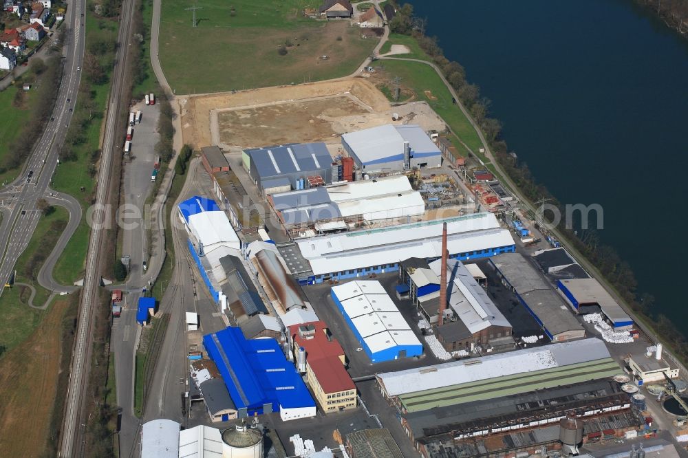 Rheinfelden (Baden) from the bird's eye view: Company grounds and facilities of Rheinfelden Alloys GmbH & Co. KG at the Rhine river in Rheinfelden (Baden) in the state Baden-Wuerttemberg, Germany