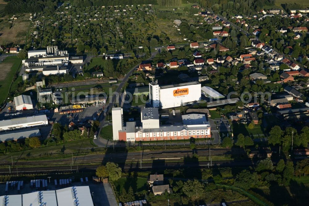 Karstädt from the bird's eye view: Company grounds and facilities of Avena Cerealien GmbH in Karstaedt in the state of Brandenburg. The white main building of the cereal producer is widely visible