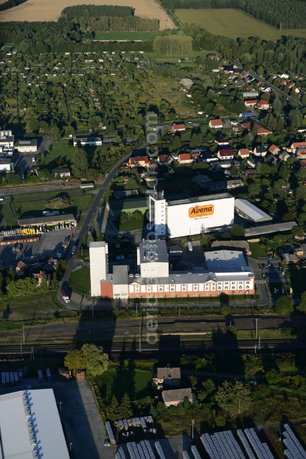 Aerial image Karstädt - Company grounds and facilities of Avena Cerealien GmbH in Karstaedt in the state of Brandenburg. The white main building of the cereal producer is widely visible