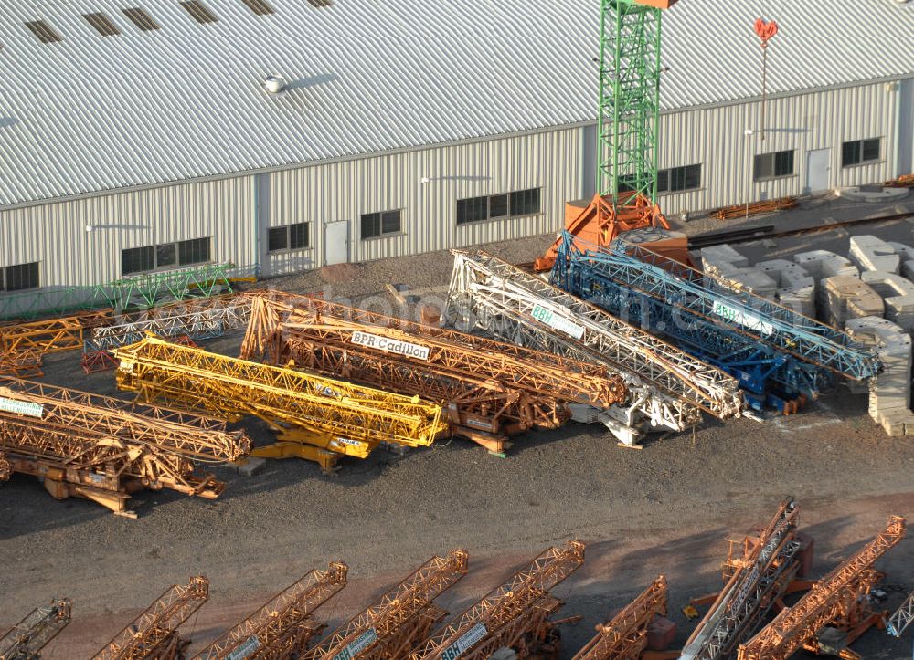 Aerial photograph Halle an der Saale - Kräne auf dem Firmengelände / Hof der BBH Baumaschinen- und Baubedarfshandelsgesellschaft mbH Halle-Neustadt in Sachsen-Anhalt. Cranes at the BBH Baumaschinen- und Baubedarfshandelsgesellschaft mbH company area in Halle-Neustadt in Saxony-Anhalt.