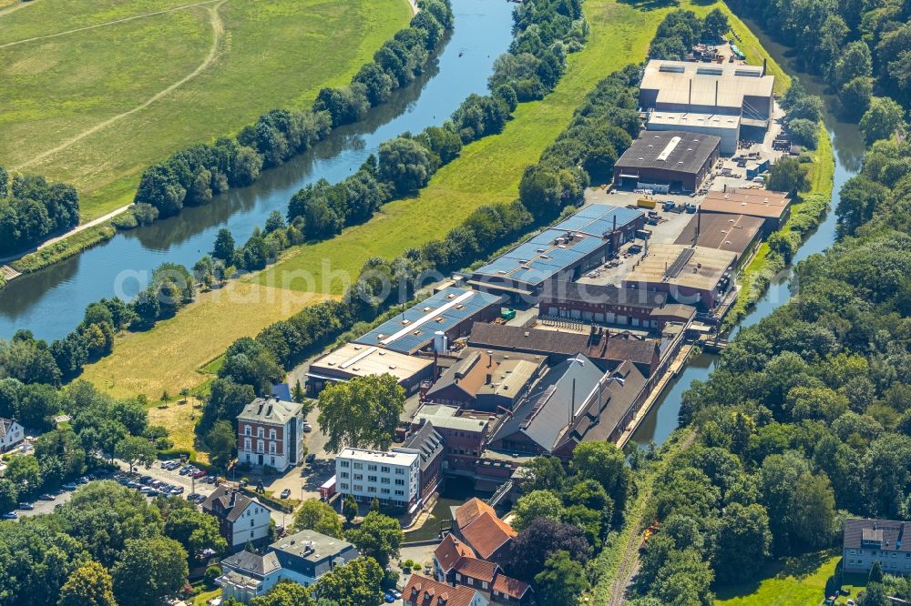 Witten from the bird's eye view: Company grounds and facilities of Friedr. Lohmann GmbH Works for steel in Witten in the state of North Rhine-Westphalia. The works are located on the riverbank of the river Ruhr