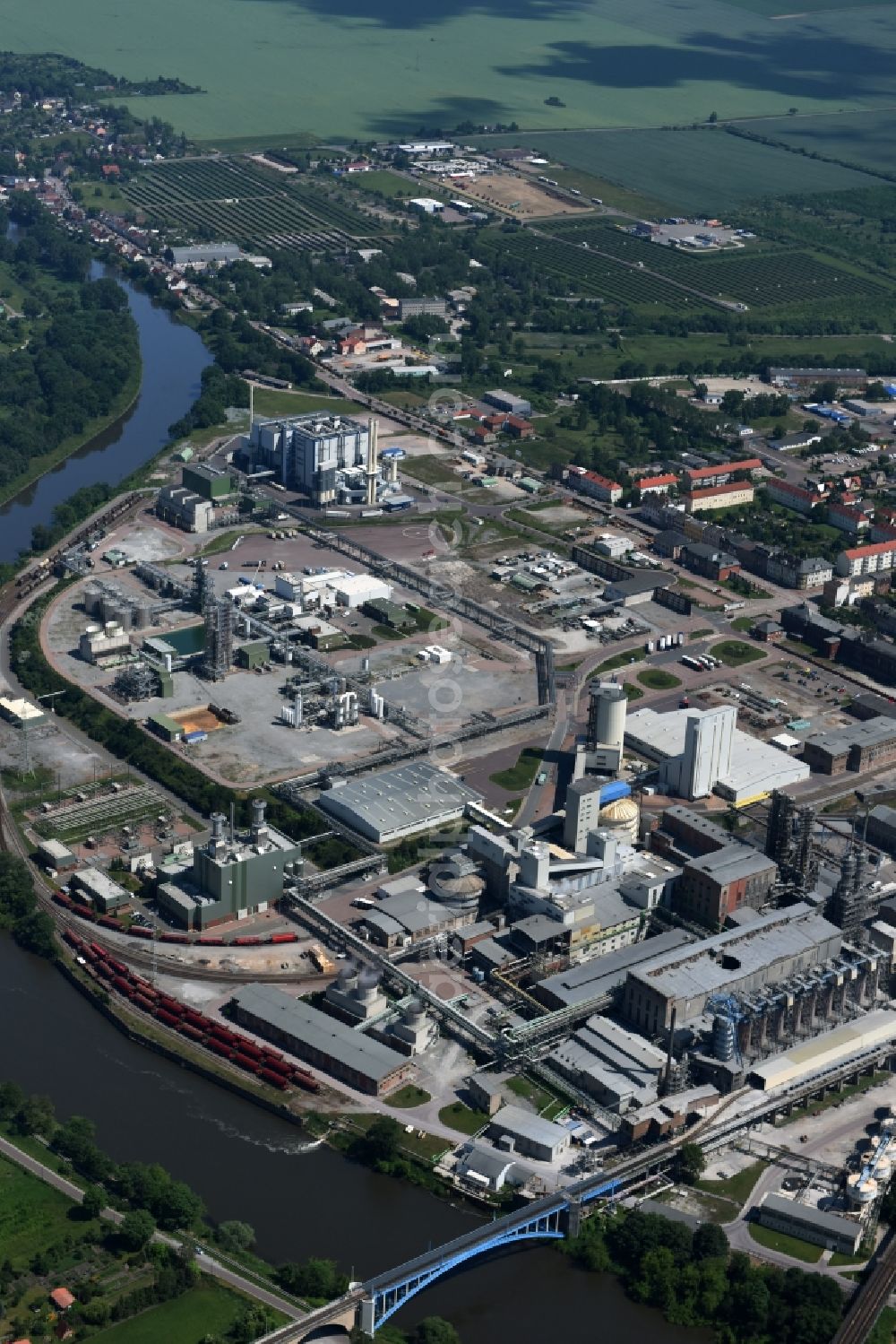 Bernburg (Saale) from the bird's eye view: Premises and facilities of the industrial park of Solvay Chemicals in Bernburg (Saale) in the state of Saxony-Anhalt. The power plant Energie Anlage Bernburg is located on the riverbank of the Saale