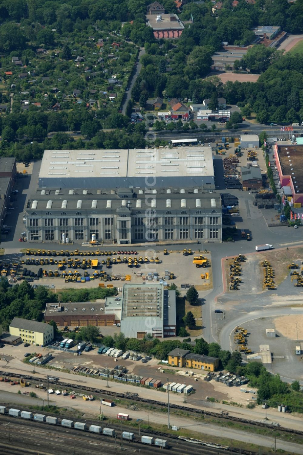 Hannover from above - Company compound of Komatsu Hanomag GmbH in the Linden-South part of Hannover in the state of Lower Saxony. The construction vehicle production company includes a large work and production facility on Hanomagstrasse in the industrial area of the borough. The vehicles are distinctly coloured in yellow