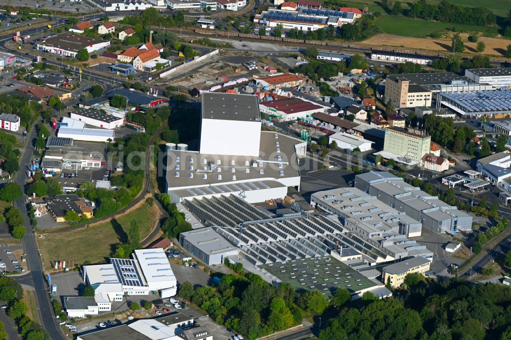 Bad Neustadt an der Saale from the bird's eye view: Company grounds and facilities of Kunert Wellpappe Bad Neustadt GmbH & Co. KG on street Besengaustrasse in the district Brendlorenzen in Bad Neustadt an der Saale in the state Bavaria, Germany