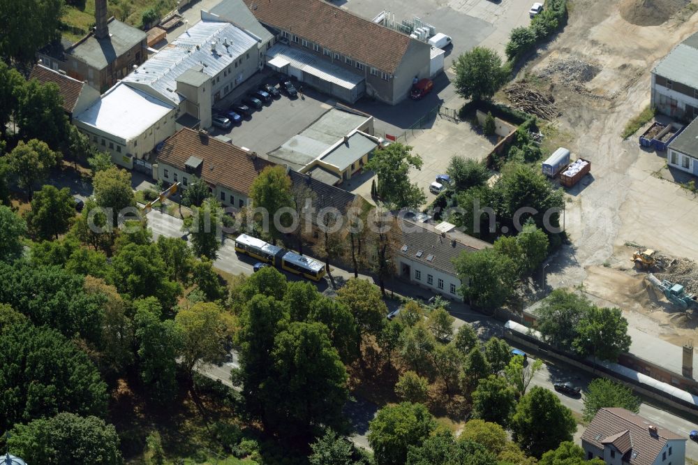 Aerial image Berlin - Company and industrial compound in the Biesdorf part of the district of Marzahn-Hellersdorf in Berlin in Germany. Construction works are taking place on the compound between Alt Biesdorf and Weissenhoeher Strasse streets, where several industrial buildings, workshops and shops are located