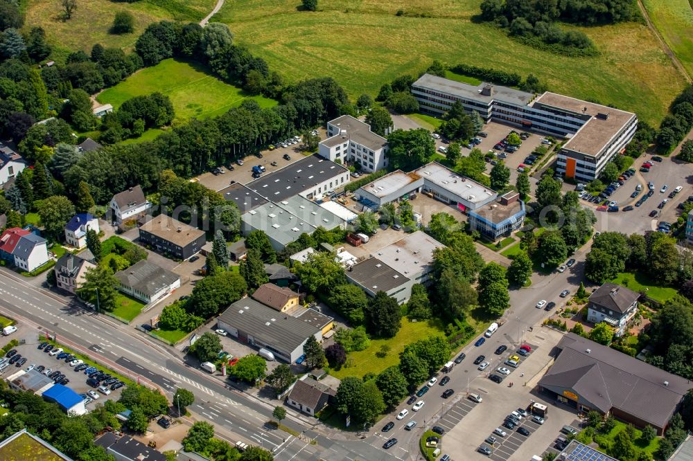 Aerial image Mülheim an der Ruhr - Premises with warehouses, corporate buildings and production of travel-it GmbH & Co. KG, the FRAGOL GmbH + Co. KG, the Vehar Logistik GmbH and Lienert Autotechnik E.K. at Remscheider street in Muelheim an der Ruhr in North Rhine-Westphalia