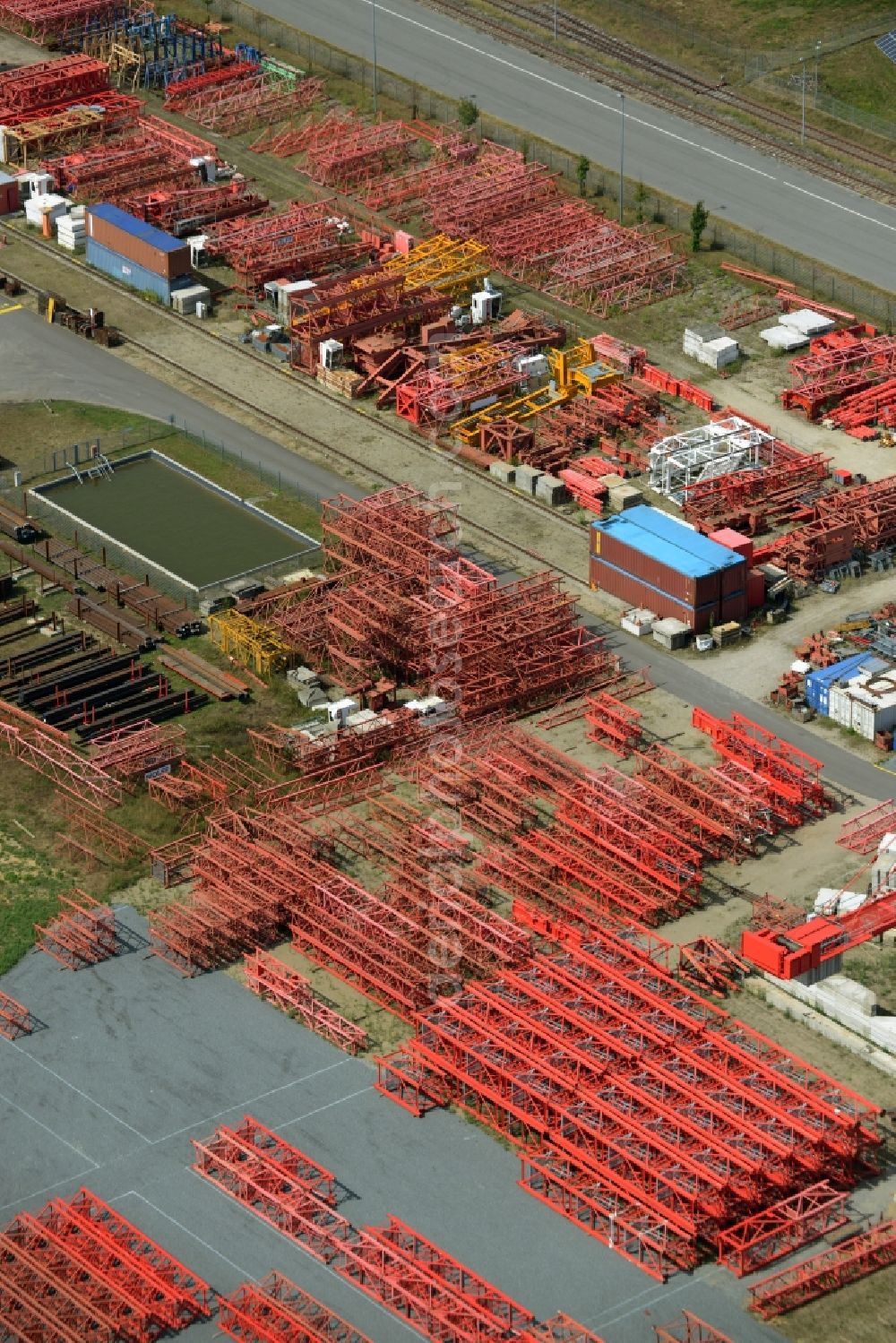 Luckau from the bird's eye view: Company grounds and facilities of the Wolffkran works in Luckau in the state of Brandenburg. Tower cranes are being produced on site with the large outdoor facilities