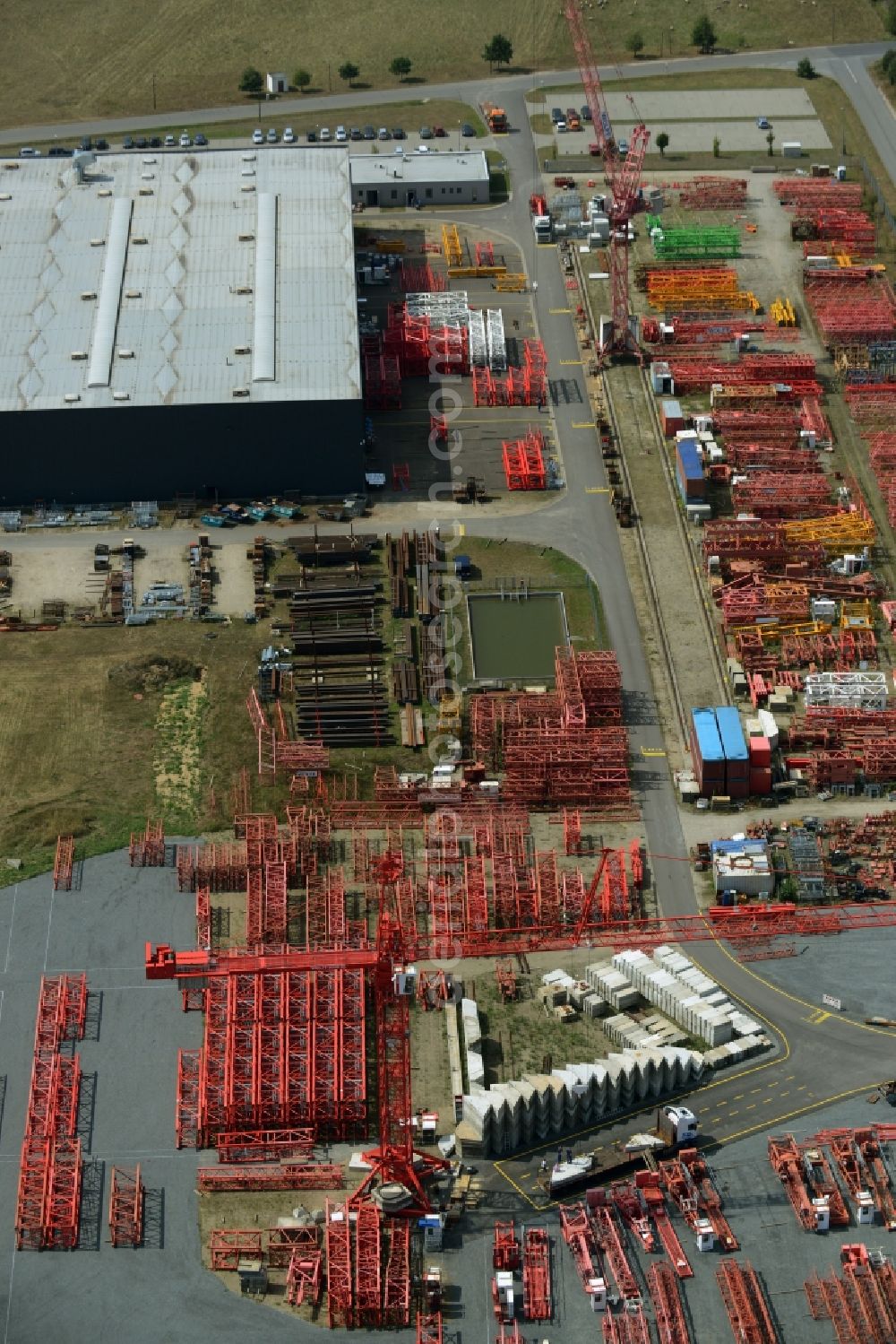 Luckau from above - Company grounds and facilities of the Wolffkran works in Luckau in the state of Brandenburg. Tower cranes are being produced on site with the large outdoor facilities