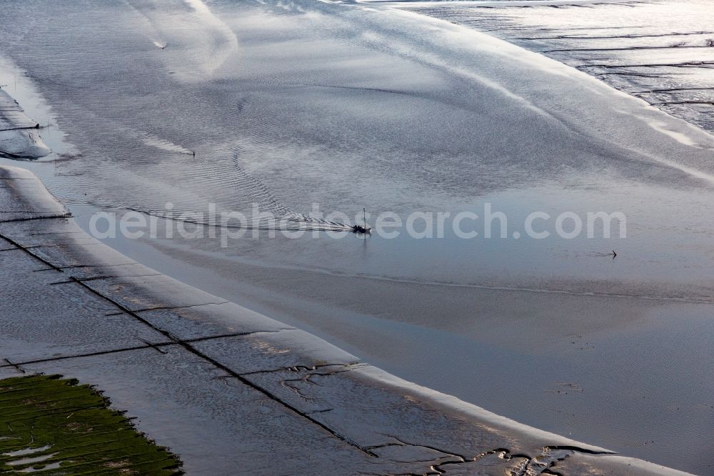 Karolinenkoog from the bird's eye view: Fishing boat returning home in the evening along the river mouth of Eider into the North Sea in Karolinenkoog in the state Schleswig-Holstein, Germany