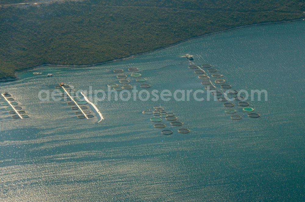 Aerial image Veli Iž - Fish farm before the island Otok iz in Veli Iž in Croatia