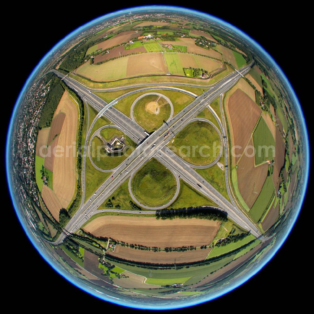 Kamen from the bird's eye view: Fish-Eye Blick auf das Autobahnkreuz Kamener Kreuz im Nordosten des Ruhrgebietes bei Kamen. Neu installiert ist das ADAC-Denkmal , einer Skluptur aus acht Figuren , welche einen ausrangierten ADAC- Helikopter tragen. Die Kunstinstallation Gelbe Engel ist ein Werk des Kuenstler Alex Gockel. Rund 200.000 Fahrzeuge passieren täglich das Kreuz und somit hat dieses kunstwerk reale Chancen, zum meistbeachteten Kunstwerk Deutschlands zu werden.