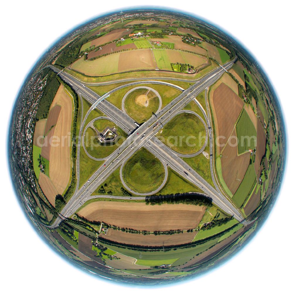 Aerial image Kamen - Fish-Eye Blick auf das Autobahnkreuz Kamener Kreuz im Nordosten des Ruhrgebietes bei Kamen. Neu installiert ist das ADAC-Denkmal , einer Skluptur aus acht Figuren , welche einen ausrangierten ADAC- Helikopter tragen. Die Kunstinstallation Gelbe Engel ist ein Werk des Kuenstler Alex Gockel. Rund 200.000 Fahrzeuge passieren täglich das Kreuz und somit hat dieses kunstwerk reale Chancen, zum meistbeachteten Kunstwerk Deutschlands zu werden.