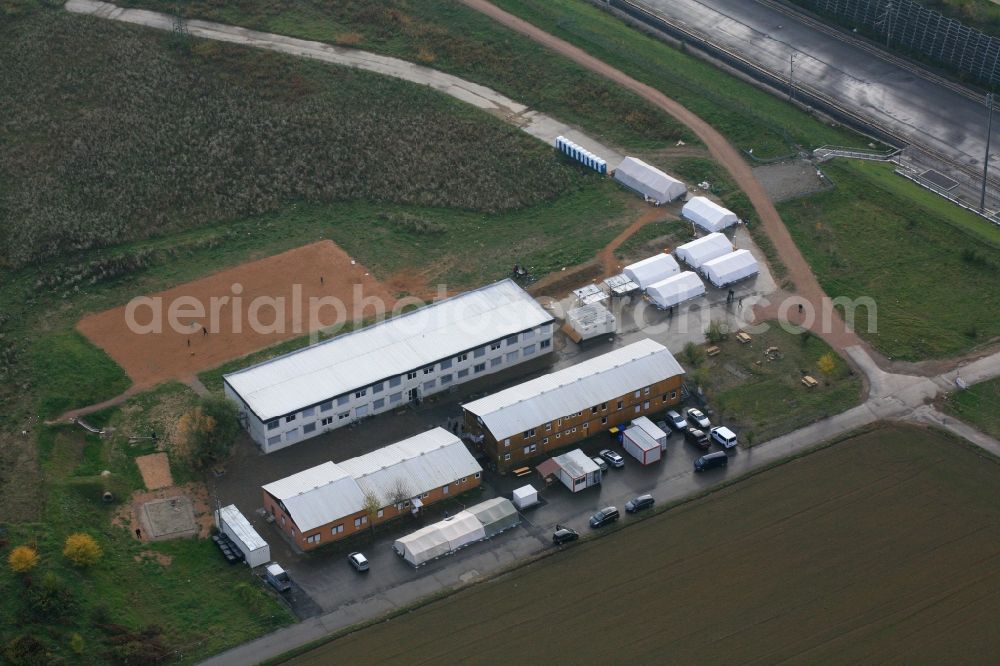 Efringen-Kirchen from the bird's eye view: Asylum accommodation buildings and refugee building with containers and tents in Efringen-Kirchen in the state of Baden-Wuerttemberg. The residences are on the grounds of the former construction site for the Katzenbergtunnel in the Upper Rhine area