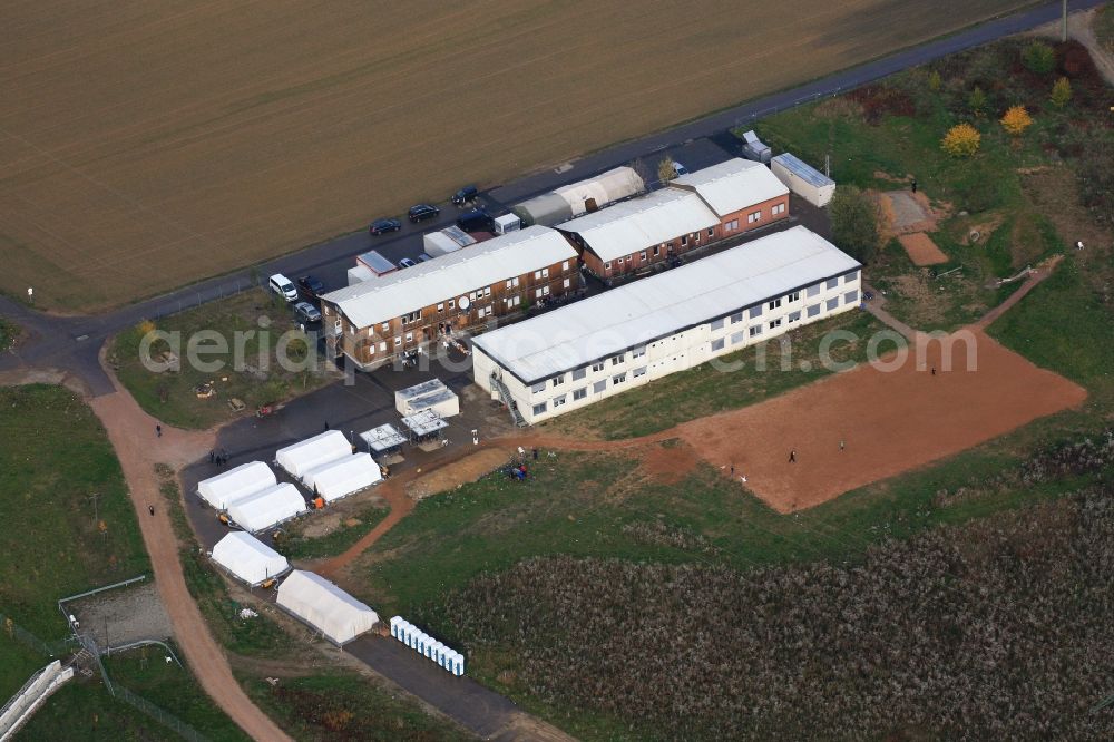 Aerial photograph Efringen-Kirchen - Asylum accommodation buildings and refugee building with containers and tents in Efringen-Kirchen in the state of Baden-Wuerttemberg. The residences are on the grounds of the former construction site for the Katzenbergtunnel in the Upper Rhine area