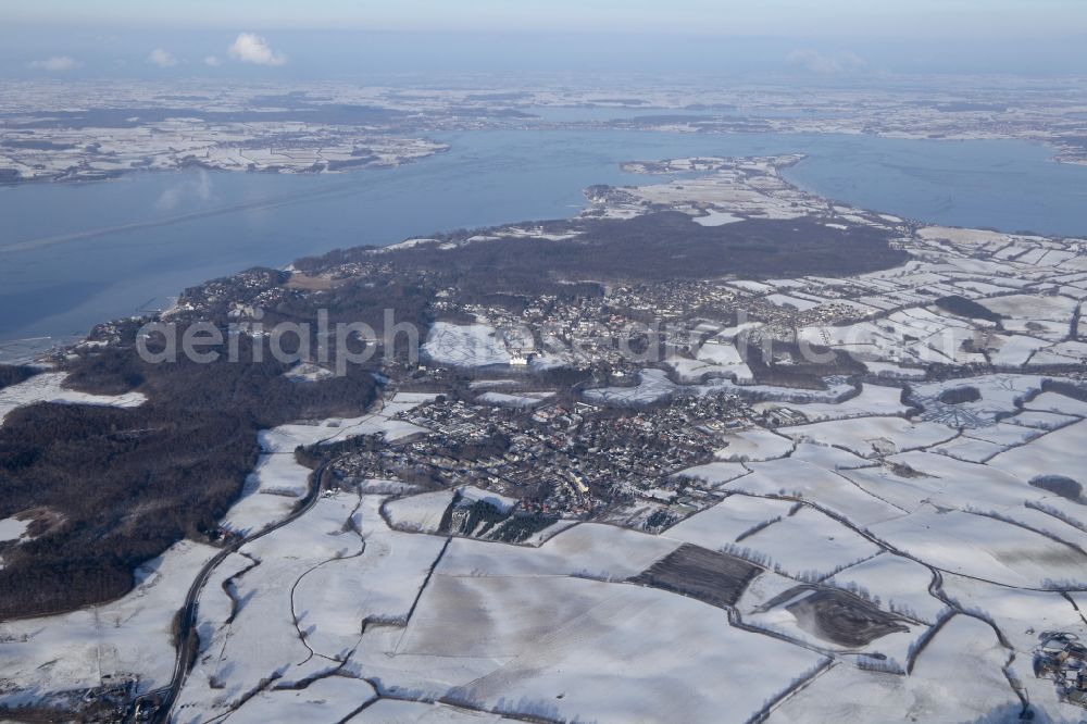 Glücksburg from the bird's eye view: Flying over the snowy landscape on the Flensburg Fjord in Gluecksburg in Schleswig-Holstein