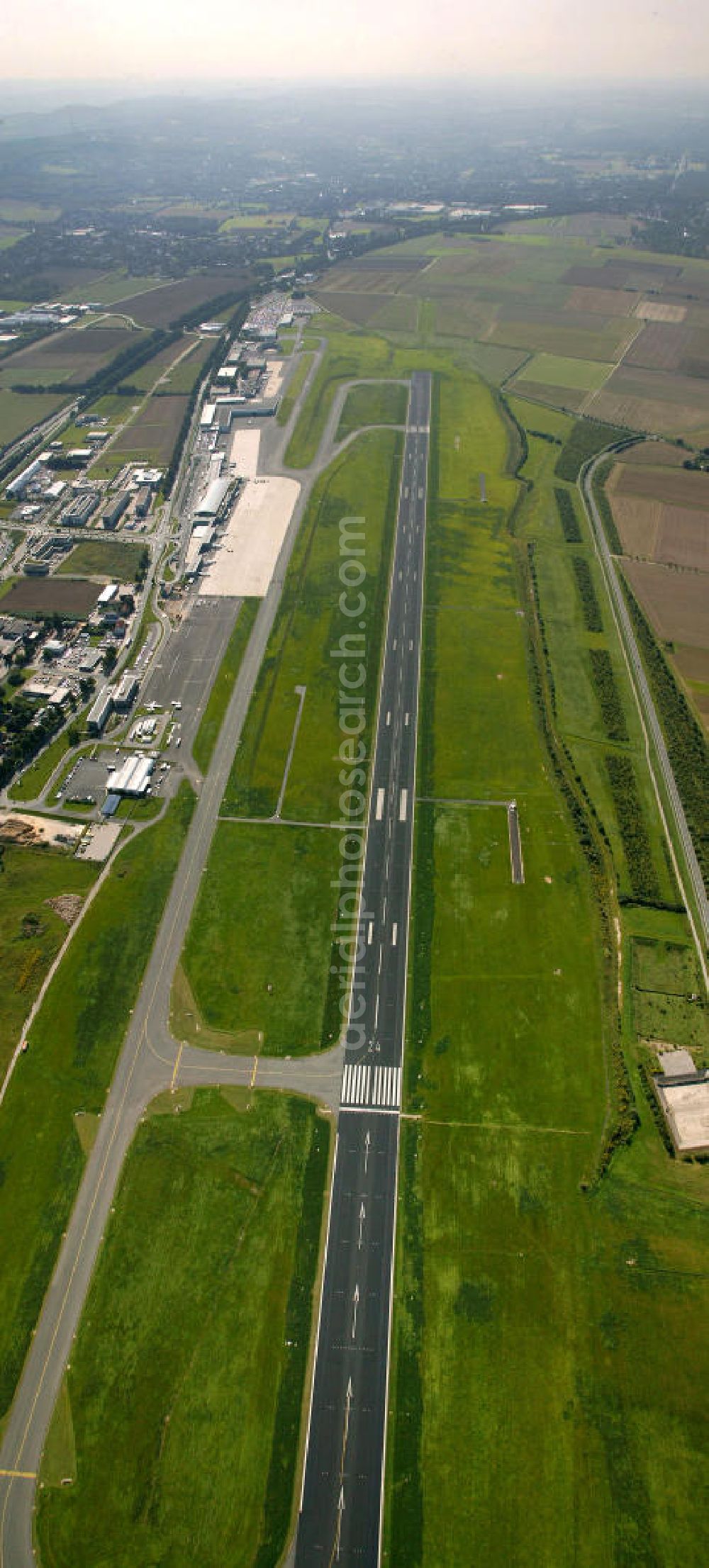 Dortmund from the bird's eye view: Blick auf den Flughafen Dortmund. Der Dortmund Airport 21 (IATA-Code DTM, ICAO-Code EDLW), ein ehemaliger Verkehrslandeplatz, entwickelte sich in den letzten Jahren zum drittgrößten Verkehrsflughafen in Nordrhein-Westfalen. View of the airport Dortmund. The Dortmund Airport 21 (IATA: DTM, ICAO EDLW), a former airfield, developed in recent years and is now the third largest airport in North Rhine-Westphalia.