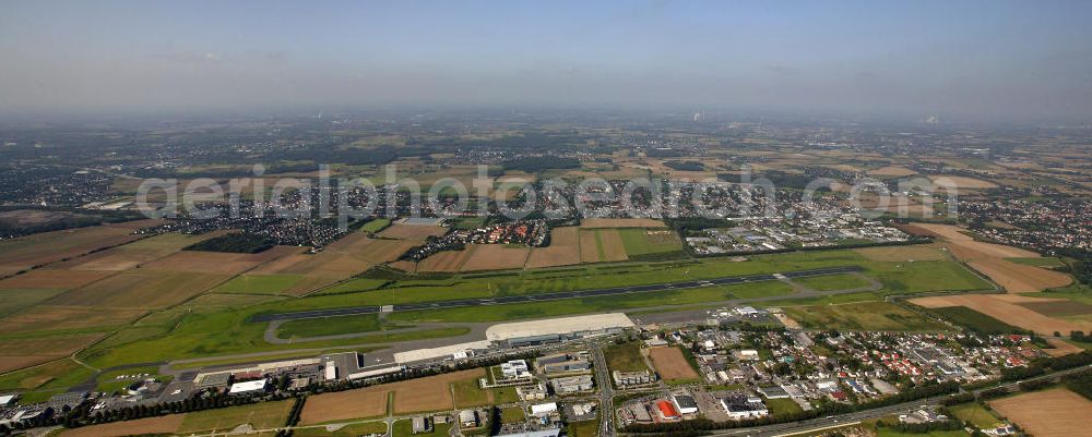 Aerial image Dortmund - Blick auf den Flughafen Dortmund. Der Dortmund Airport 21 (IATA-Code DTM, ICAO-Code EDLW), ein ehemaliger Verkehrslandeplatz, entwickelte sich in den letzten Jahren zum drittgrößten Verkehrsflughafen in Nordrhein-Westfalen. View of the airport Dortmund. The Dortmund Airport 21 (IATA: DTM, ICAO EDLW), a former airfield, developed in recent years and is now the third largest airport in North Rhine-Westphalia.