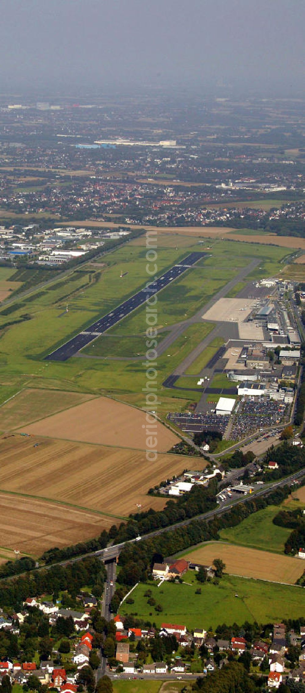 Dortmund from above - Blick auf den Flughafen Dortmund. Der Dortmund Airport 21 (IATA-Code DTM, ICAO-Code EDLW), ein ehemaliger Verkehrslandeplatz, entwickelte sich in den letzten Jahren zum drittgrößten Verkehrsflughafen in Nordrhein-Westfalen. View of the airport Dortmund. The Dortmund Airport 21 (IATA: DTM, ICAO EDLW), a former airfield, developed in recent years and is now the third largest airport in North Rhine-Westphalia.