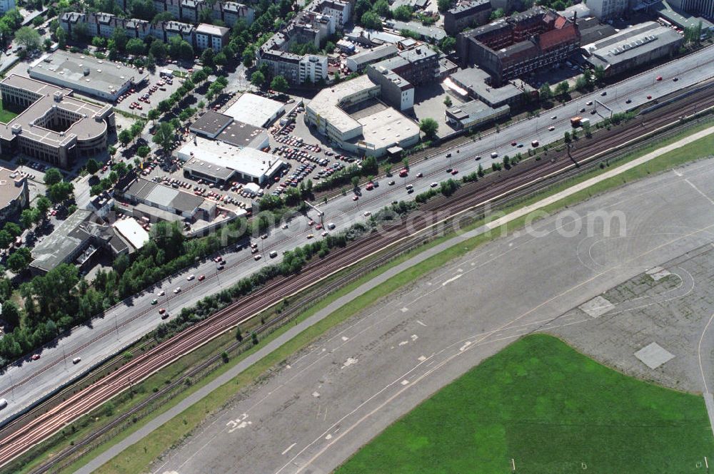 Berlin Tempelhof from above - Blick über das Rollweg vom Flughafen Tempelhof auf die S-Bahn-Schienen und die Autobahn A 100. View over the taxiway of Tempelhof Airport on the city railway and the motorway A100.