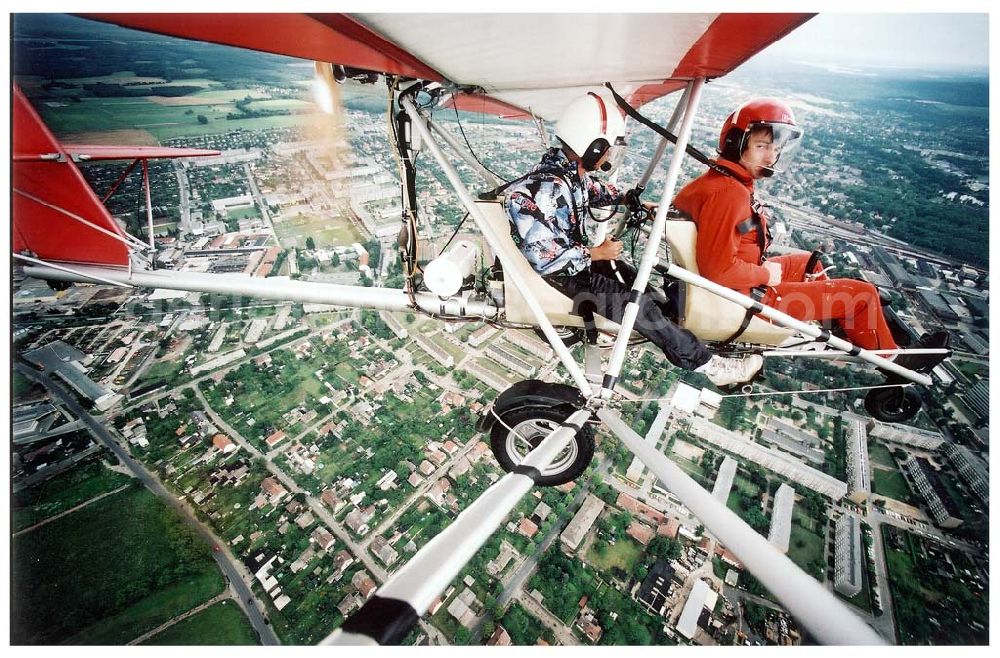 Aerial photograph Fürstenwalde / BRB - Fluglehrer Rolf Bausewein (hinten) mit einem Fluggast in einem Ultraleichtflugzeug der Flugschule Märkische Schweiz des Flugplatzes Eggersdorf beim Flug über Fürstenwalde.