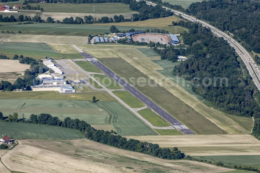 Landshut from above - Runway with tarmac terrain of airfield Landshut-Ellermuehle in Landshut in the state of Bavaria. The runway and the hangars are surrounded by fields and meadows and located in the North of the federal motorway A92