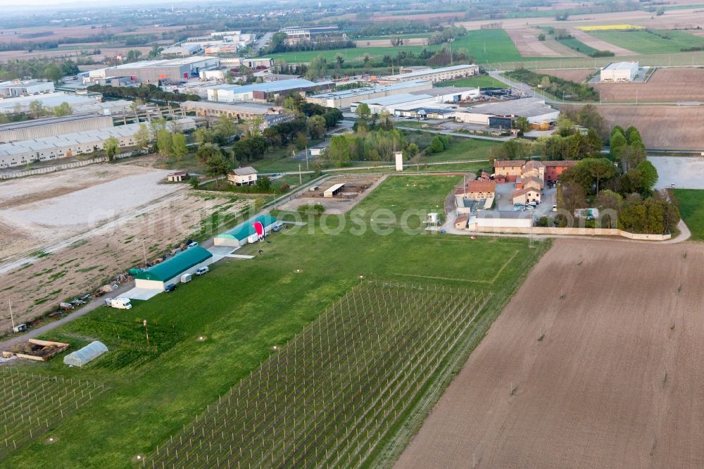 Codroipo from above - Runway with tarmac terrain of airfield Pista Aerei Leggeri in Codroipo in Friuli-Venezia Giulia, Italy