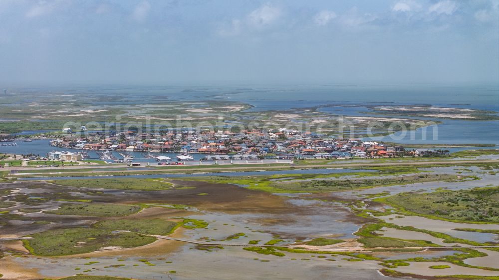 Aerial image Port Aransas - Runway with tarmac terrain of airfield Mustang Beach Airport on street Piper Boulevard in Port Aransas in Texas, United States of America